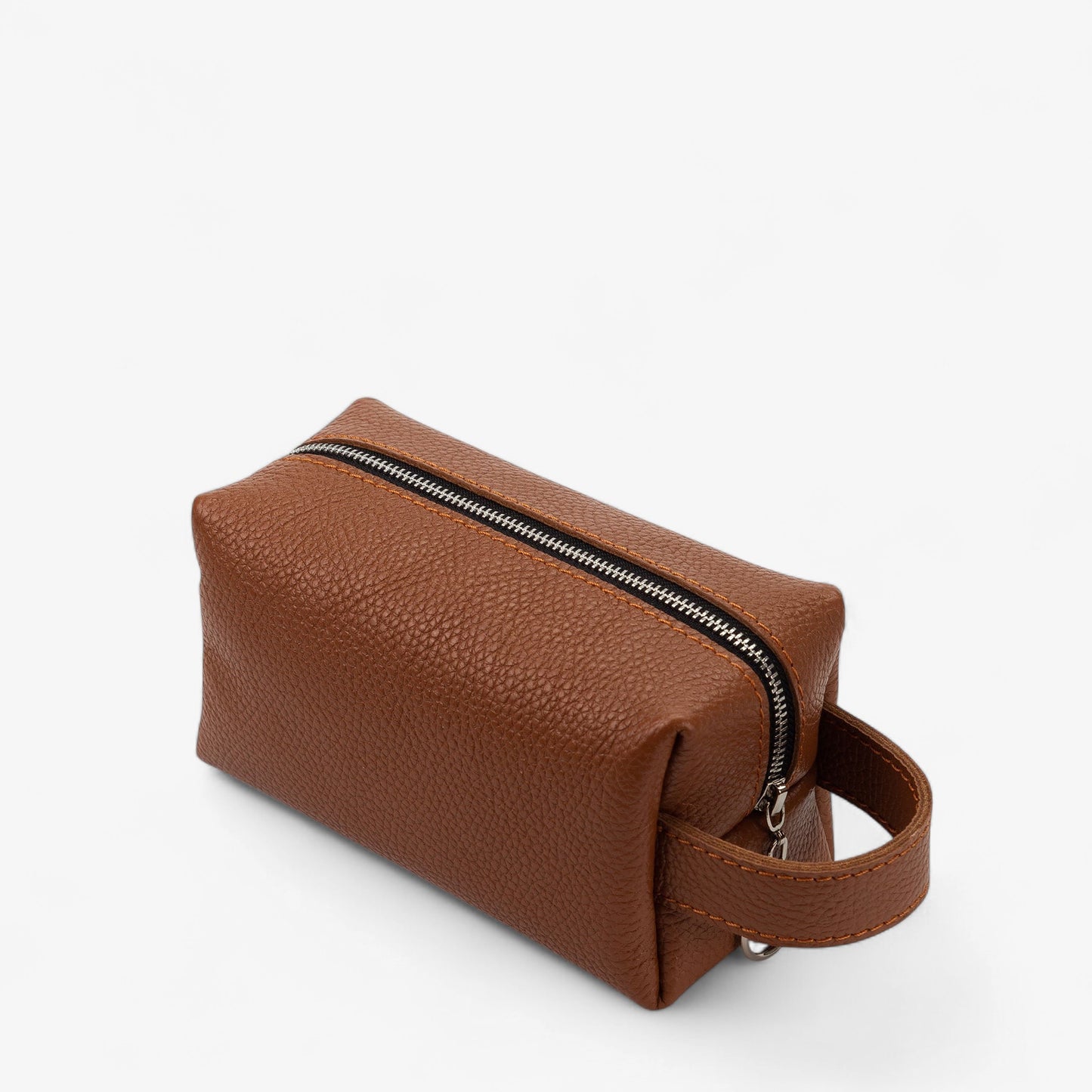 Brown leather toiletry bag with a zipper on a white background