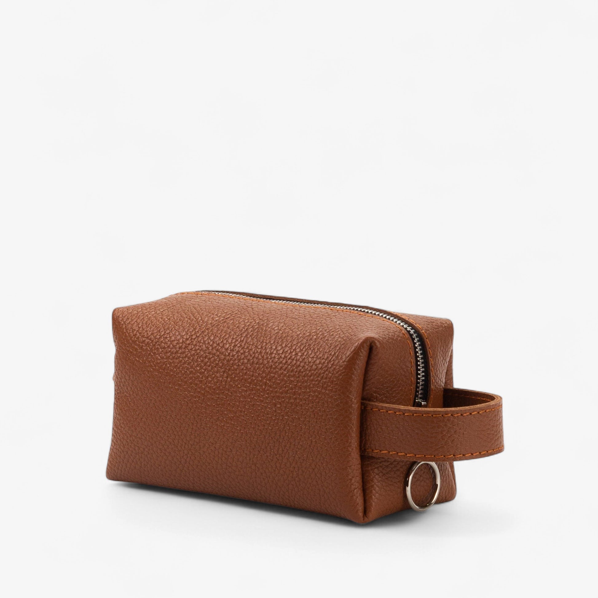 Brown leather toiletry bag with a strap on a white background