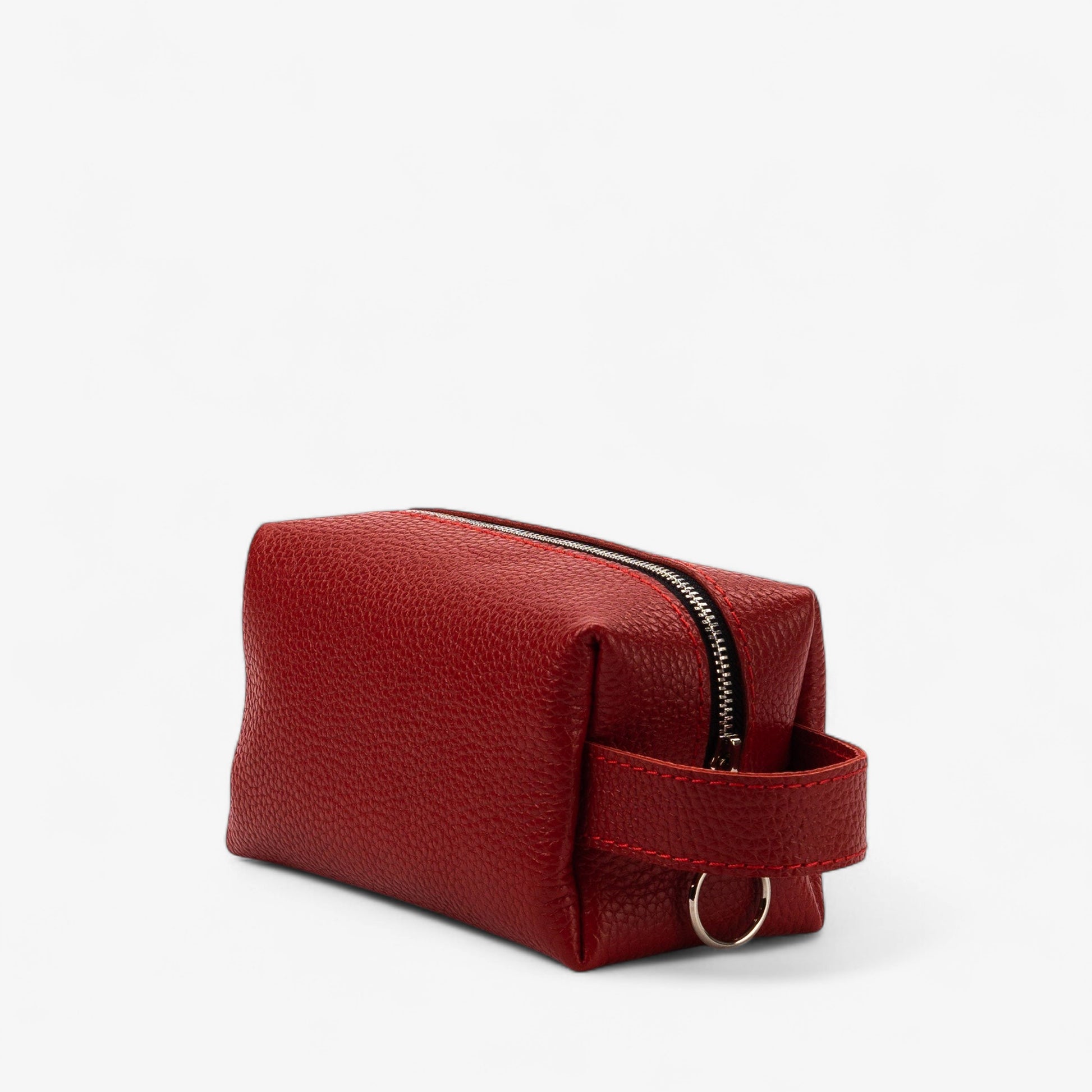 Red toiletry bag with a strap on a white background