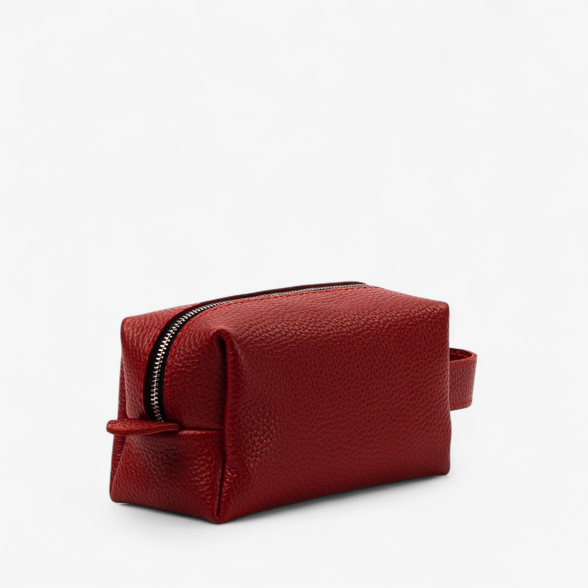 Red leather toiletry bag with a zipper on a white background