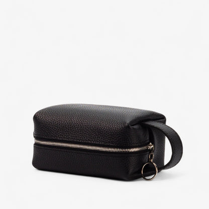 Black leather toiletry bag with a zipper on a white background