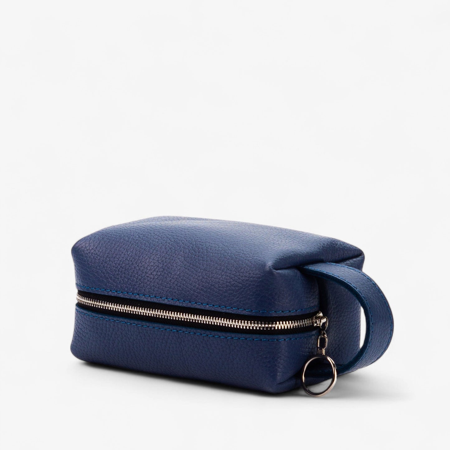 Blue toiletry bag with a gold zipper on a white background