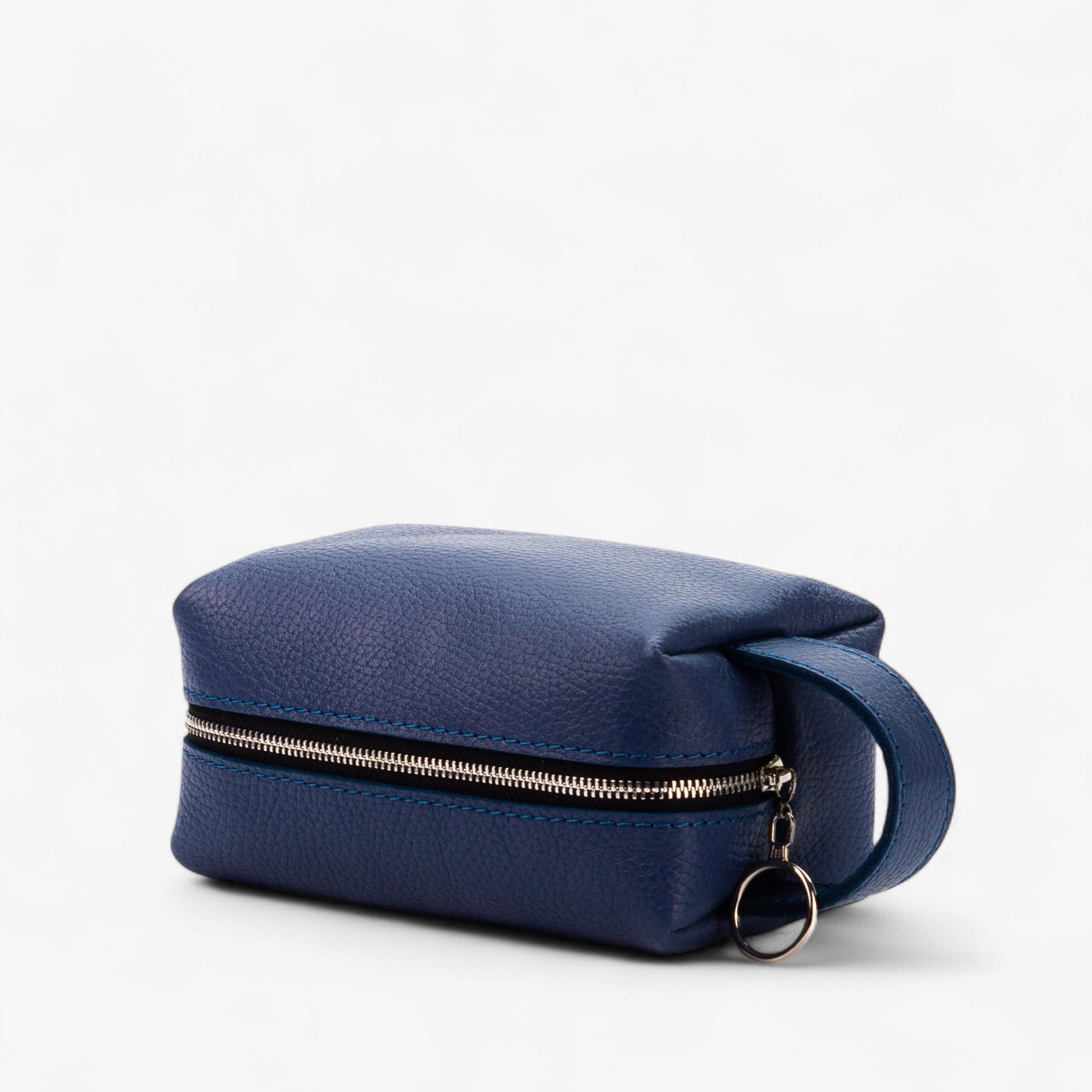 Blue toiletry bag with a gold zipper on a white background