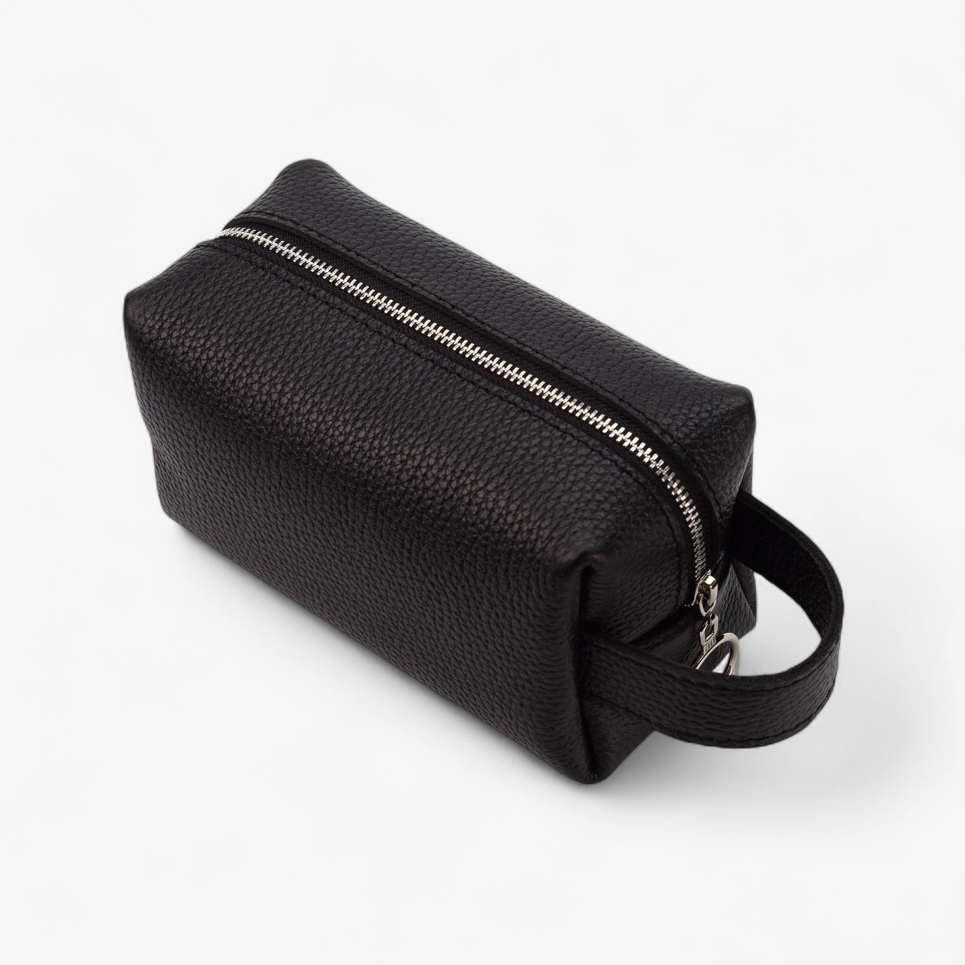 Black leather toiletry bag with a zipper on a white background
