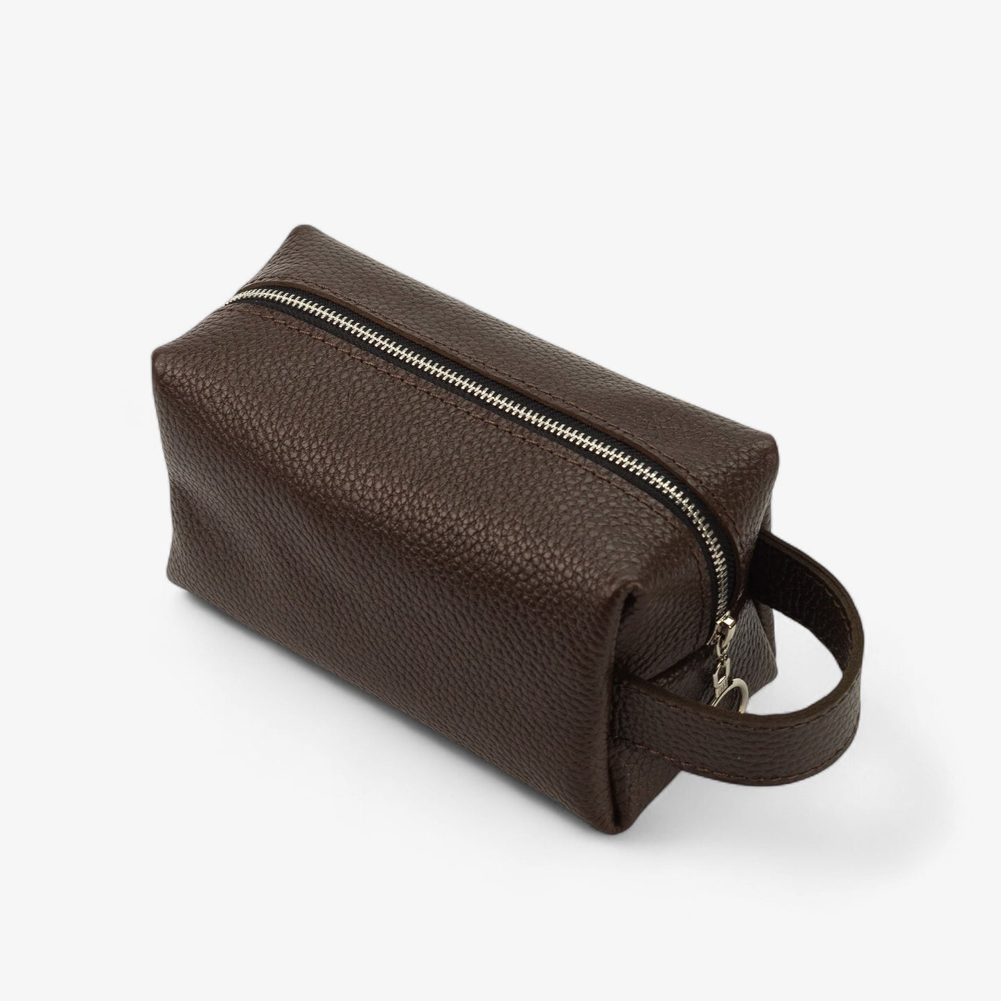 Brown leather toiletry bag with a zipper on a white background