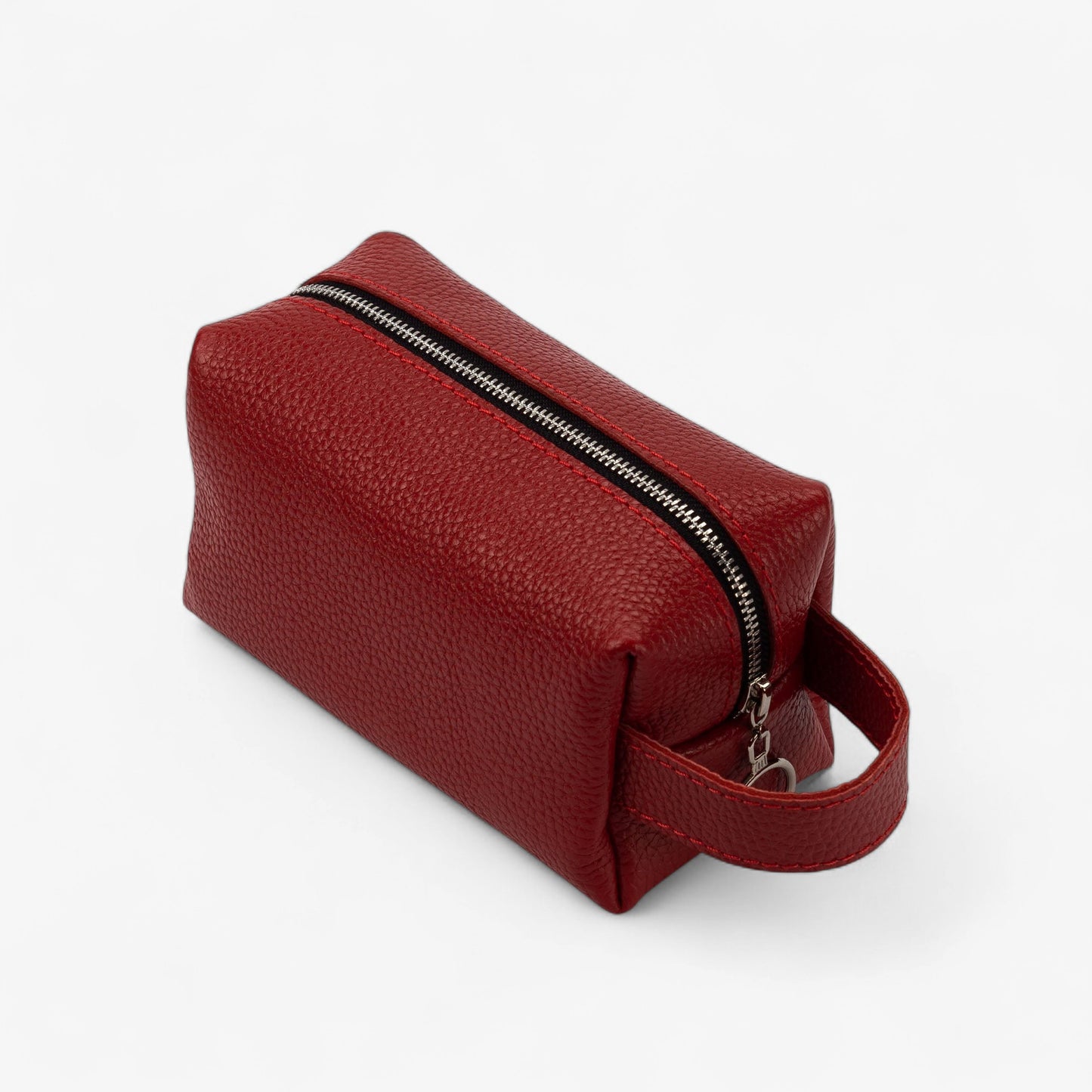 Red toiletry bag with a zipper on a white background