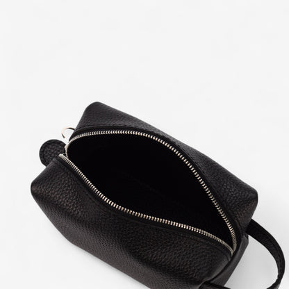 Black leather bag with zipper on a white background