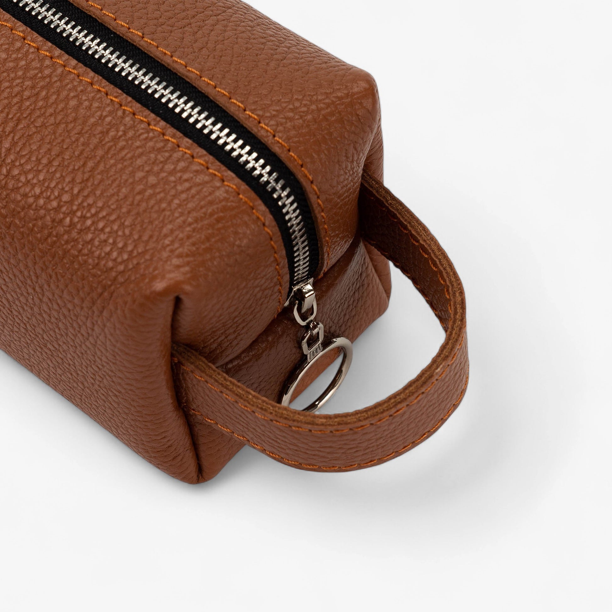 Brown leather bag with a zipper on a white background