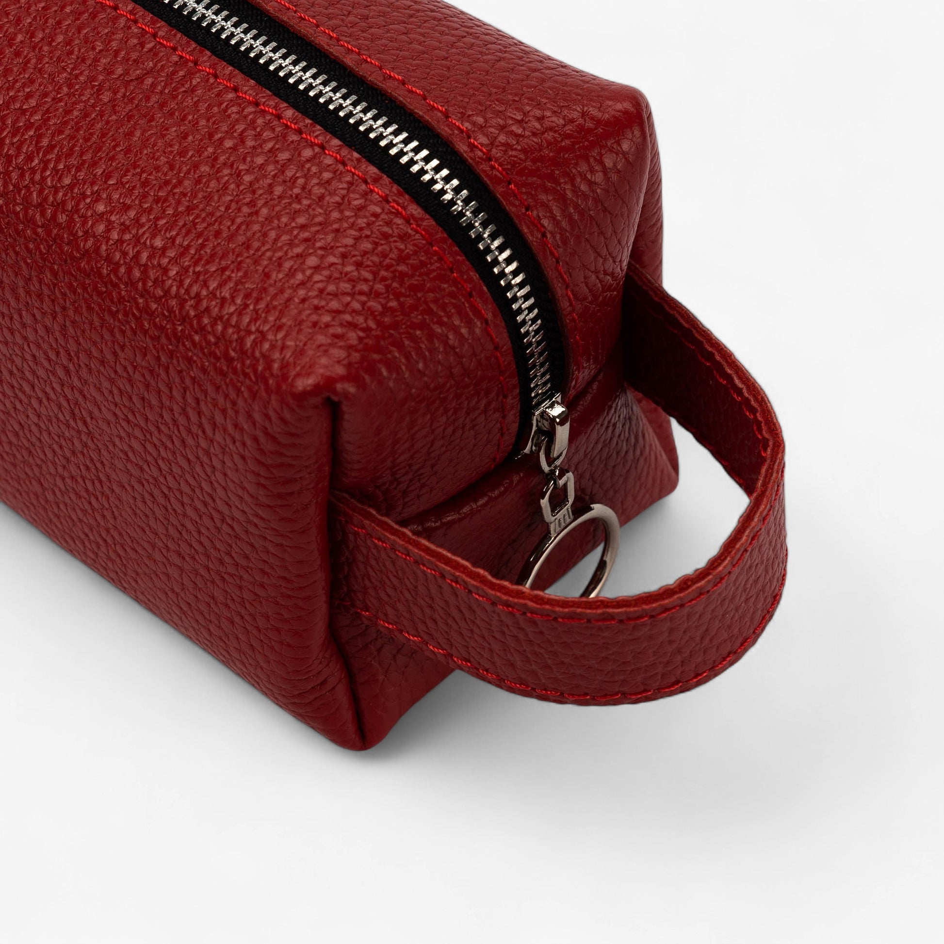 Red leather pouch with a zipper on a white background