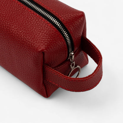 Red leather pouch with a zipper on a white background