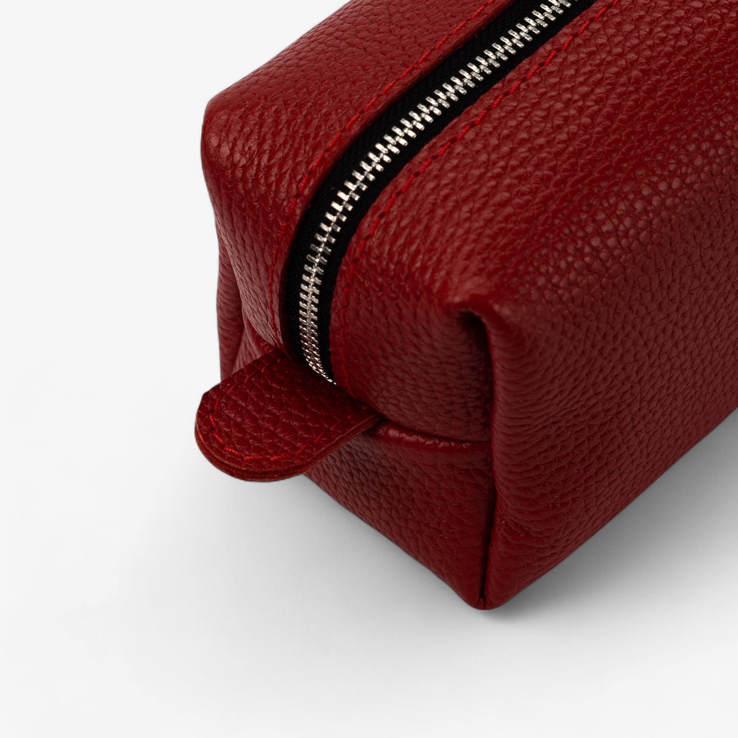 Red leather pouch with a zipper on a white background