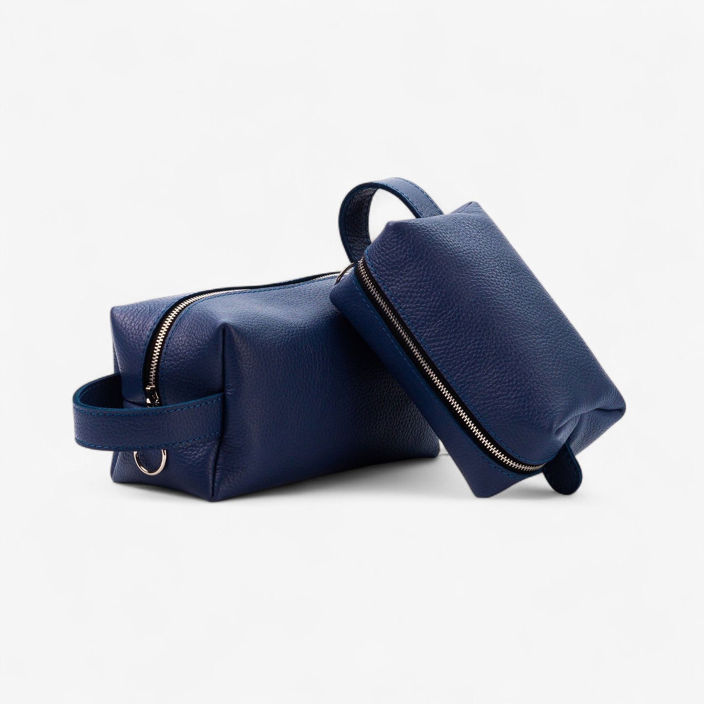 Two navy blue leather bags on a white background