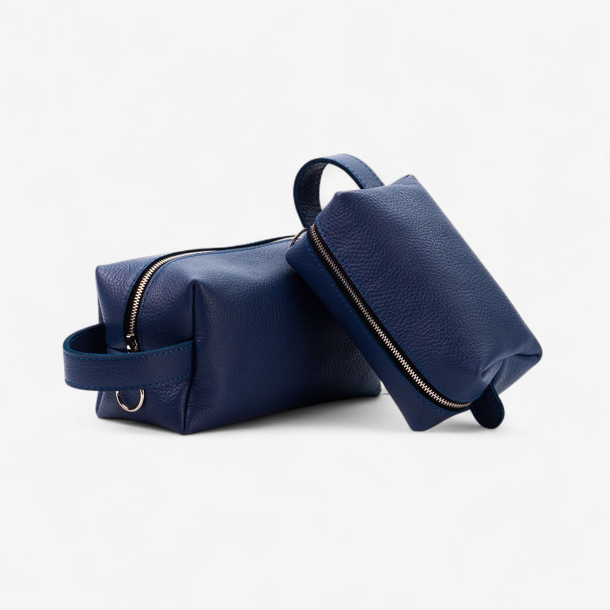 Two navy blue leather bags on a white background