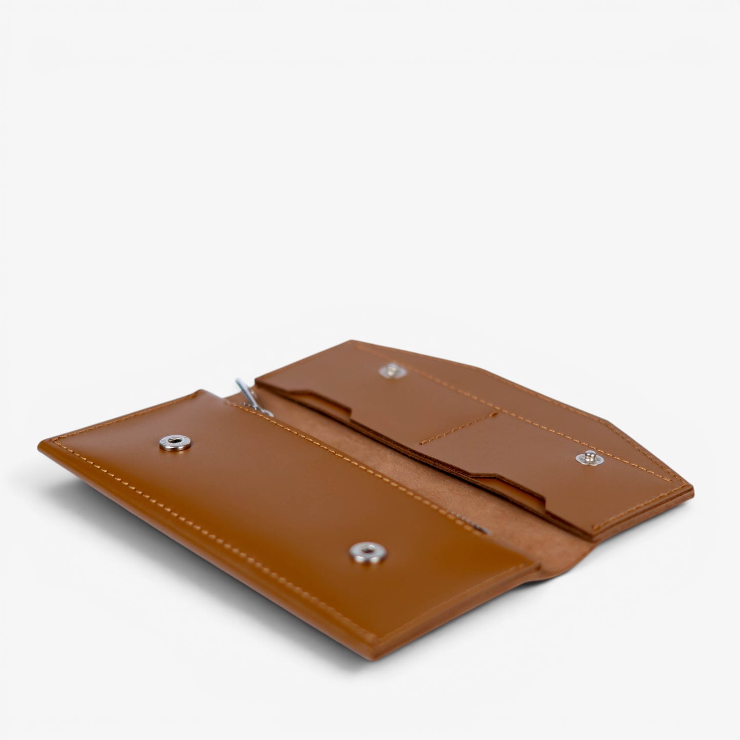 Open brown handmade leather wallet, empty interior with card slots and compartments