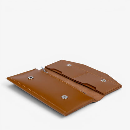 Open brown handmade leather wallet, empty interior with card slots and compartments