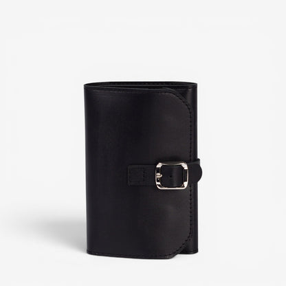 Black Elin jewelry roll closed with leather buckle strap