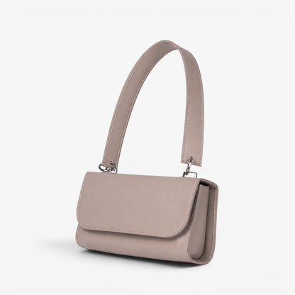 Gray leather handmade handbag with a shoulder strap on a white background