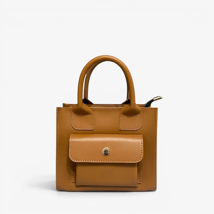 Pache Sigil mini tote bag in smooth brown leather with a front pocket and top handles. Versatile for everyday or special occasions.